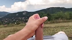 Young man masturbating in the nature with sexy big cock