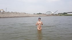 Girl bathes naked in the river and masturbates on the shore